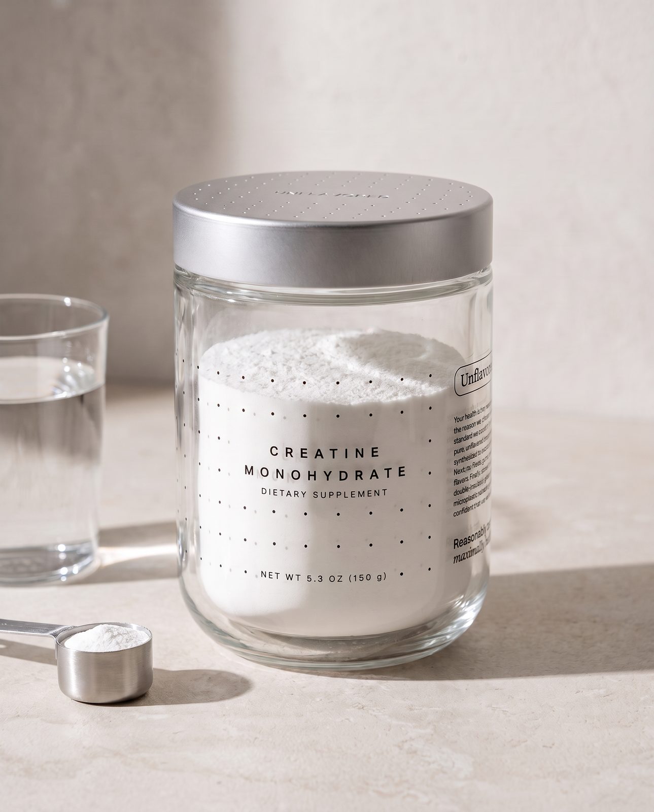 The Unflavored jar on a limestone kitchen counter in morning light, beside a glass of water and a steel scoop